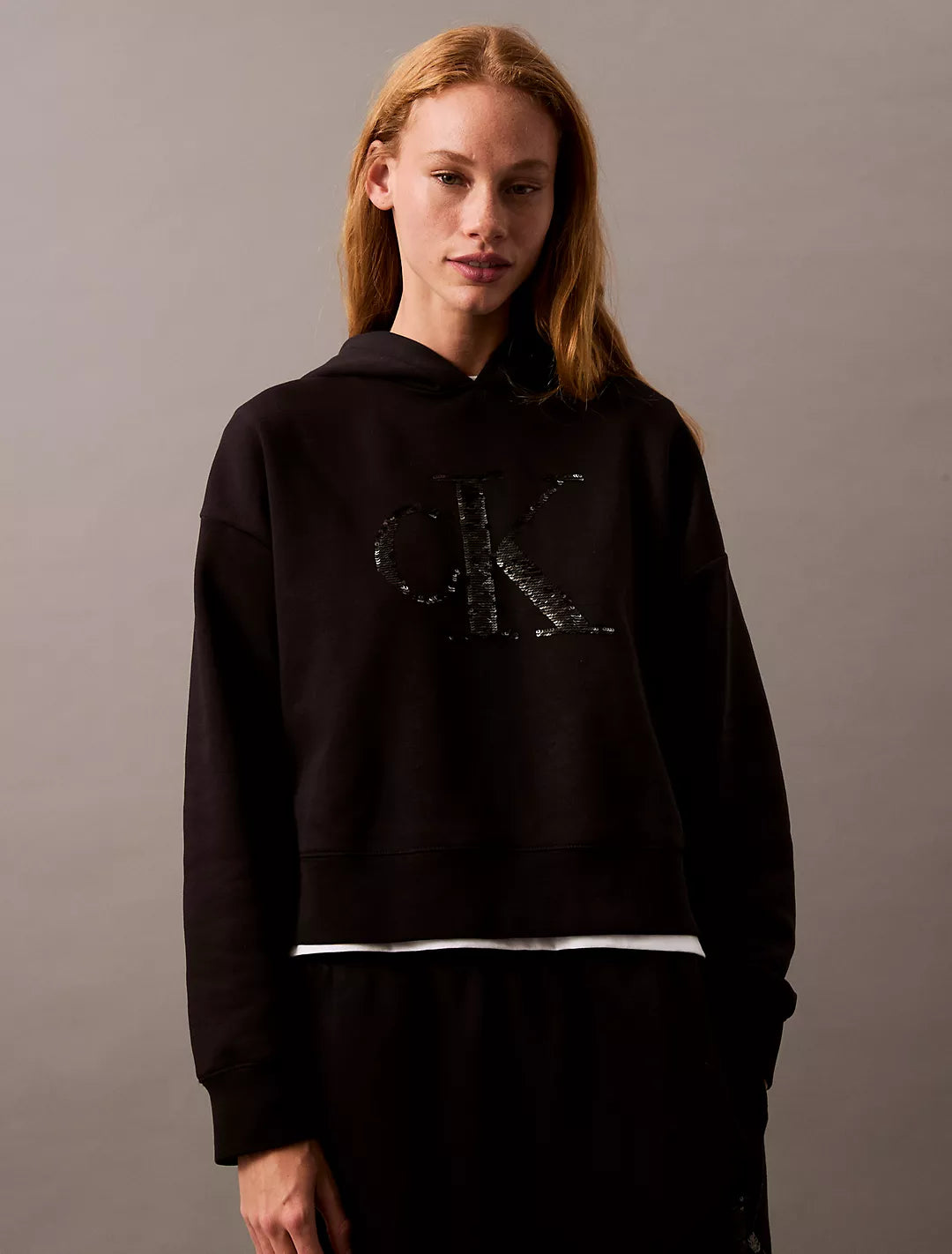 Calvin Klein Sequin Monogram Logo Cropped Hoodie - Women Hoodie with Front Slit Layering Stylish Calvin Klein Sequin Monogram Logo Cropped Hoodie - Women Hoodie with Front Slit Layering Stylish